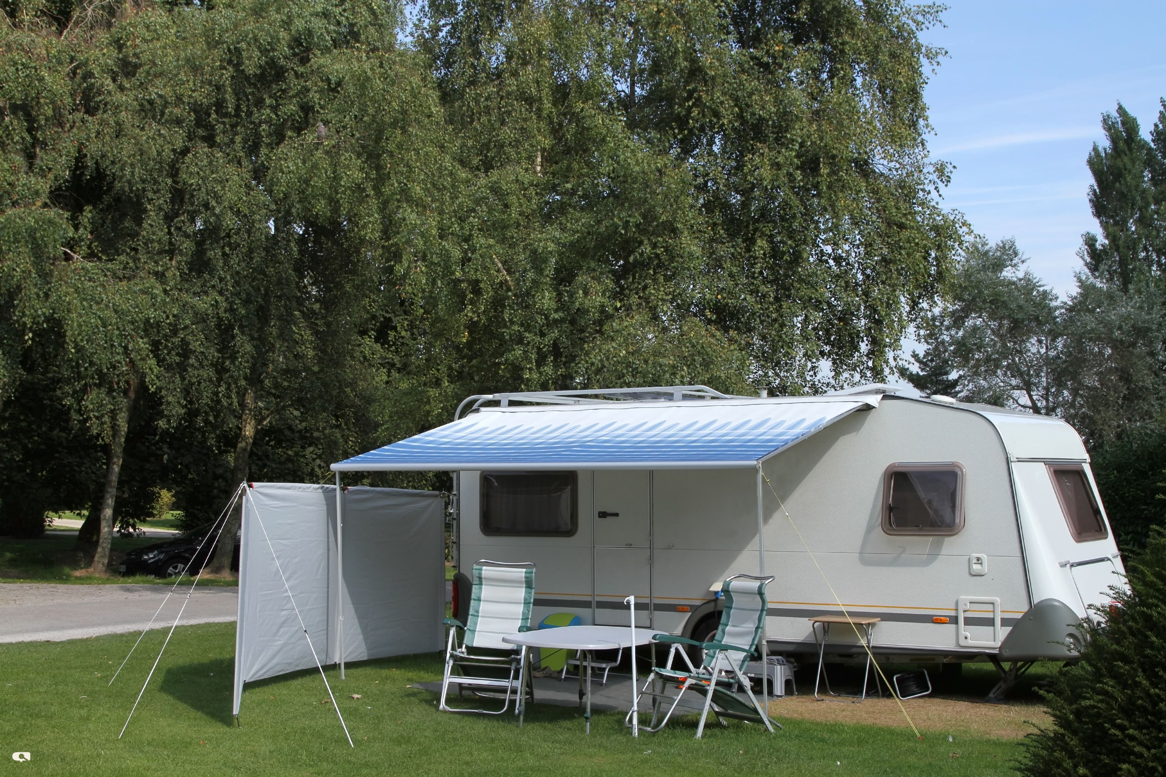 A couple relaxing by their caravan